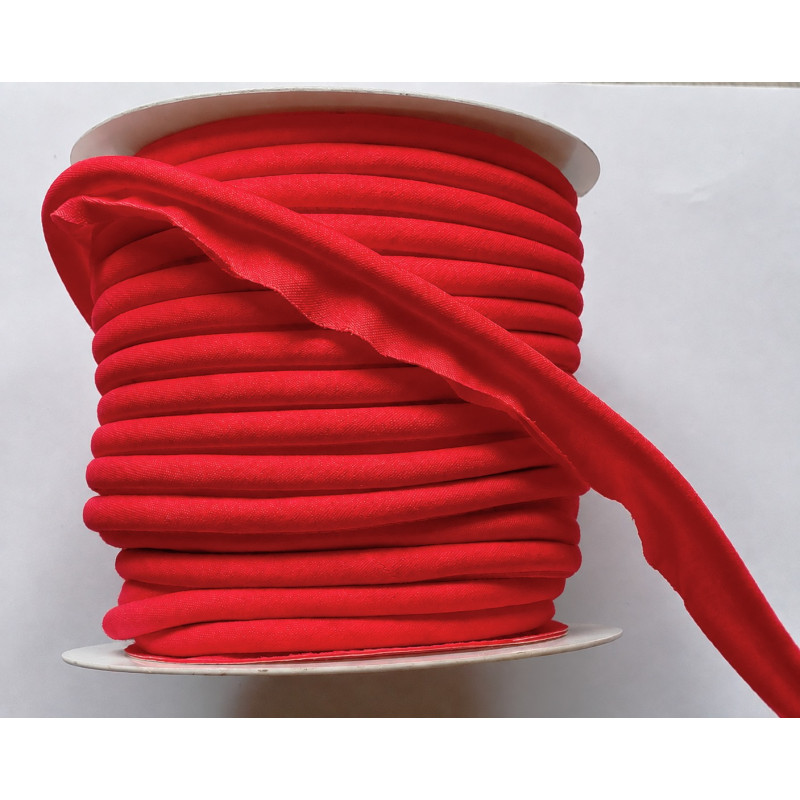 A full reel of plain, Red flanged piping cord on white background