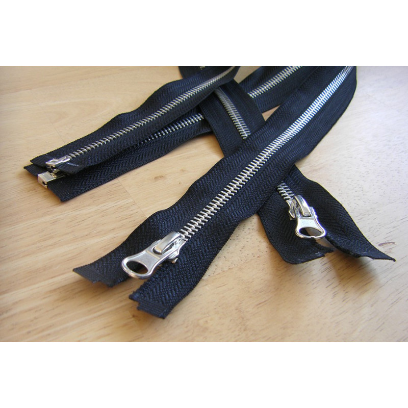 open-ended metal zip nickel teeth color on a wooden table, set of zips