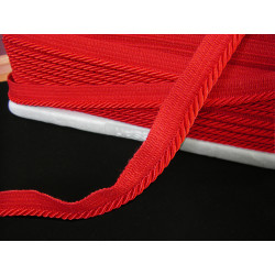 Flanged piping cord  in red color, 5mm wide piping , full reel on black table