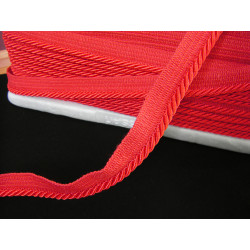 Twisted flanged piping cord 7mm wide in red color from the reel on black background