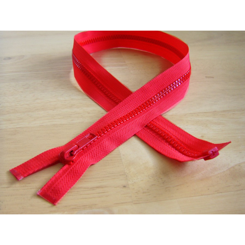 chunky zip - open end - light red - 45cm placed on a wooden background