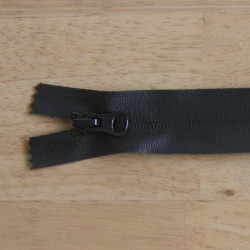 waterproof zip - black color - closed  end - 20cm long on a wooden background