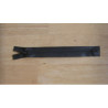 waterproof zip - black color - closed  end - 20cm long on a wooden background