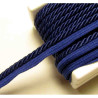 Twisted flanged piping cord 7mm wide in navy color from the reel on white background