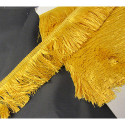 silky cut fringe - gold color - 60mm long on a black background