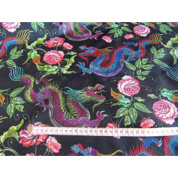 Water-resistant canvas fabric - Dragons&Roses on black with a measuring tape, to show the size of the design