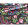 Water-resistant canvas fabric - Dragons&Roses on black placed across the frame with a fold