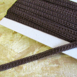 Upholstery braid, 15mm wide  in  dark brown color, full reel across the table
