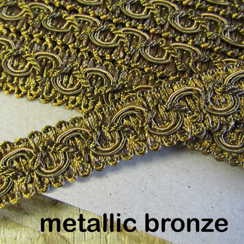 Upholstery braid, 18mm wide  in  metallic bronze color, full reel across the table