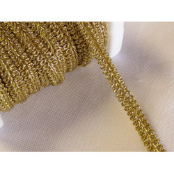 Brocade upholstery braid, 9mm wide  in  gold color, full reel across the table