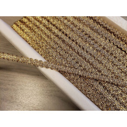 Brocade upholstery braid, 9mm wide  in  gold color, full reel across the table