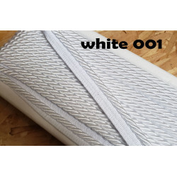 Twisted flanged piping cord 7mm wide in white color from the reel on a wooden table
