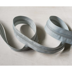 continuous zip in size 5 in grey color, twisted on the white background