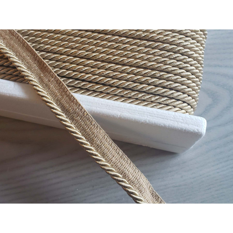 Flanged piping cord  in beige color, 5mm wide piping , full reel on the table