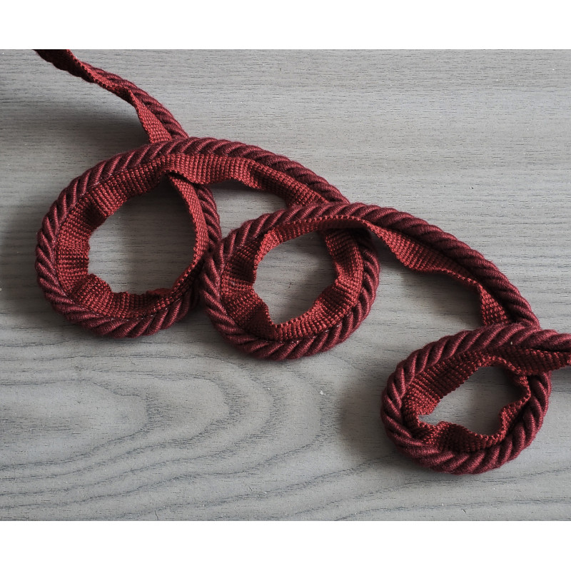 Upholstery, thick flanged cotton rope piping cord 8mm - burgundy, twisted on the table