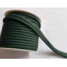 A full reel of plain, dark green flanged piping cord on white background