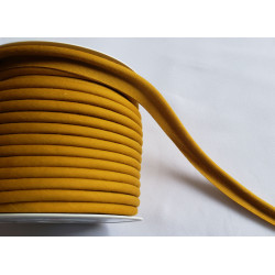 A full reel of plain, ochre flanged piping cord on white background