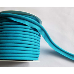 A full reel of plain, turquoise flanged piping cord on white background