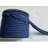 A full reel of plain, navy blue flanged piping cord on white background