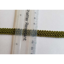 Upholstery braid, 9mm wide  in olive color, close up on the braid with the ruler