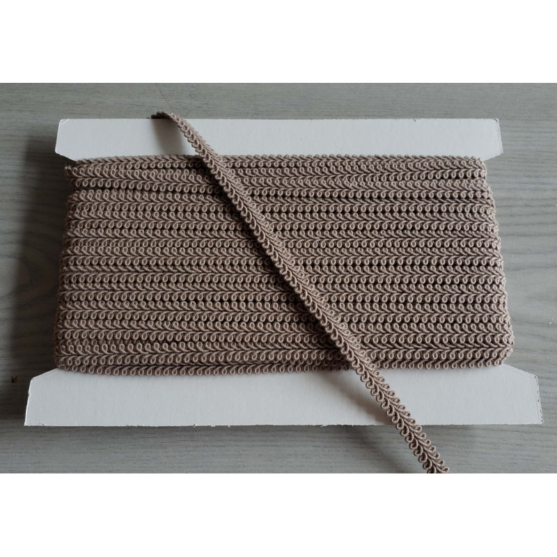 Scroll upholstery braid, 9mm wide  in  dark beige color, full reel on grey background