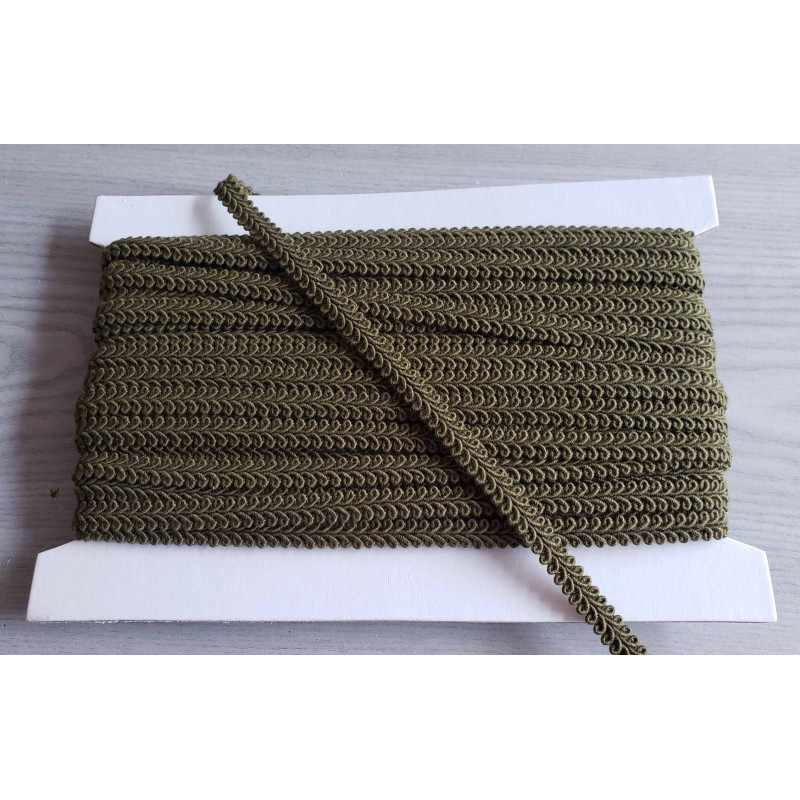 Scroll upholstery braid, 9mm wide  in  olive green color, full reel on grey background