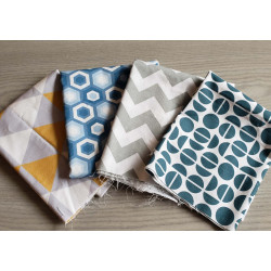 Cotton fabric remnants bundle , set of geometric patterns, placed on grey table