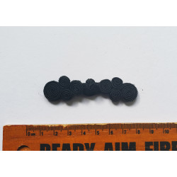 Chinese frog fastener in black color on a white background with the ruler