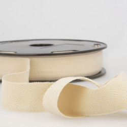 Full reel of white cotton twill tape on the table