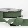 Full reel of bottle green cotton twill tape on the table