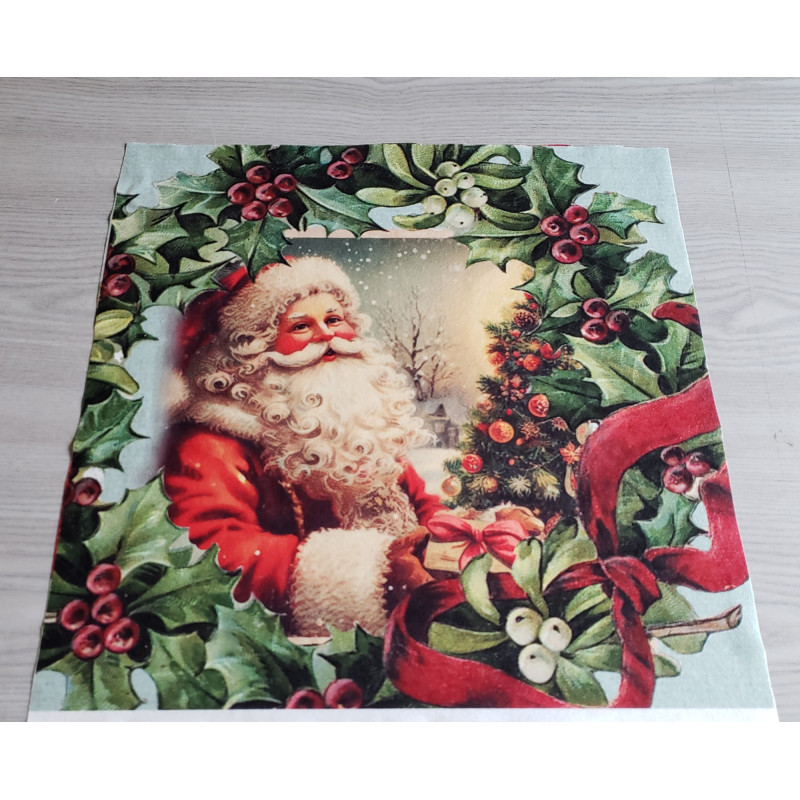 Christmas cushion panel- Victorian Santa theme, placed on grey table