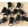 set of zip sliders in size 10 for  waterproof zip in black color on a wooden background