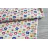 Multiflower white -medium-weight cotton with Scandinavian-style small flowers, the fabric folded on a grey table