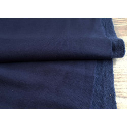 Sweatshirt jersey fabric - navy, to photo shows the fabric with the fold on grey table