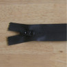 waterproof zip - black color - closed  end - 22cm long on a wooden background