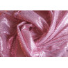 flexible sequin fabric- blush pink color, the fabric twisted into a swirl