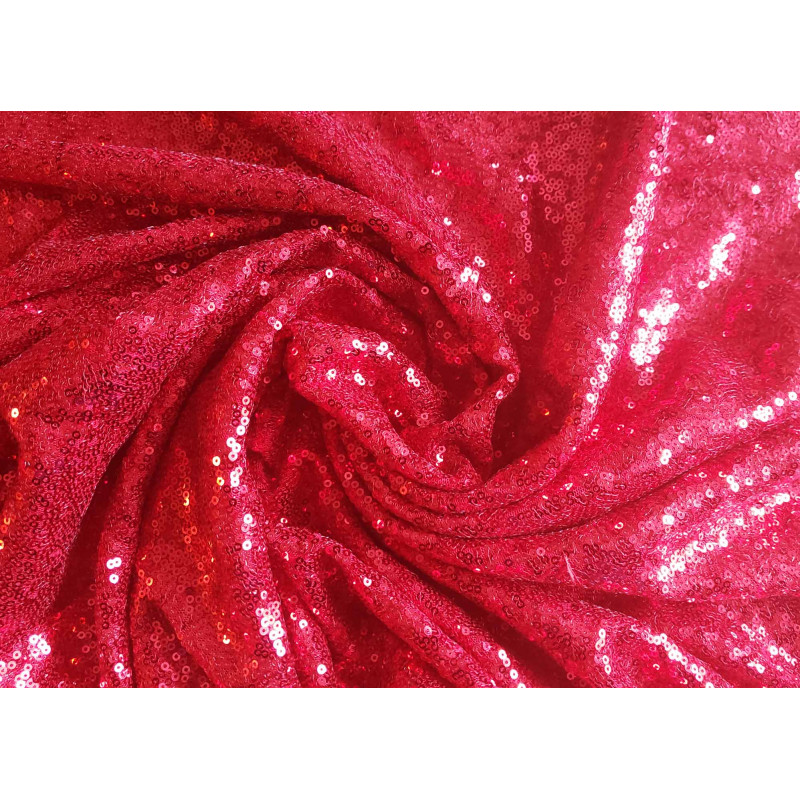 flexible sequin fabric- intense red color, the fabric twisted into a swirl