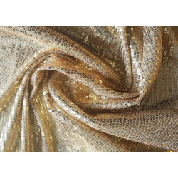 flexible sequin fabric- gold color, the fabric twisted into a swirl