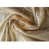 flexible sequin fabric- gold color, the fabric twisted into a swirl