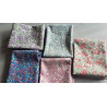 Floral fabric pre cuts bundle - 5 pieces, placed on the grey table