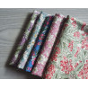 Floral fabric pre cuts bundle - 5 pieces, placed on the grey table, showing all designs of fabric