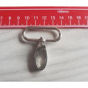 Swivel hook - metal - silver 38mm placed on a grey table with measuring tape, to show the size