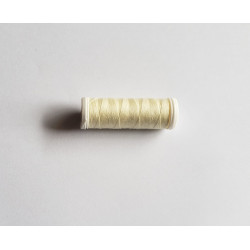 Sewing machine thread - light cream color - 200m spool, placed on a white background