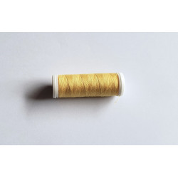 Sewing machine thread - pale orange color - 200m spool, placed on a white background