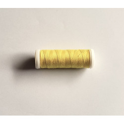 Sewing machine thread - yellow color - 200m spool, placed on a white background