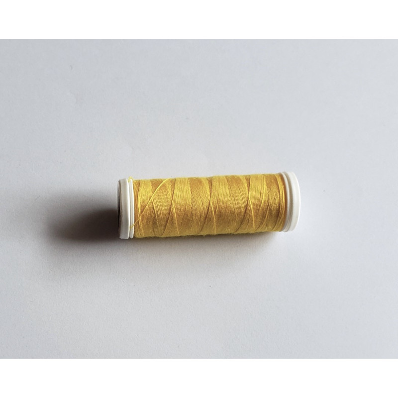 Sewing machine thread - sunflower yellow color - 200m spool, placed on a white background