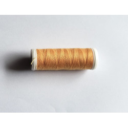 Sewing machine thread -light orange color - 200m spool, placed on a white background