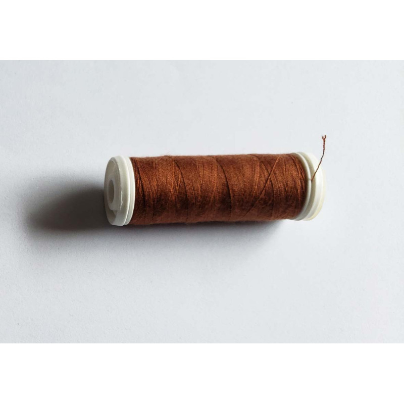 Sewing machine thread -chestnut color - 200m spool, placed on a white background