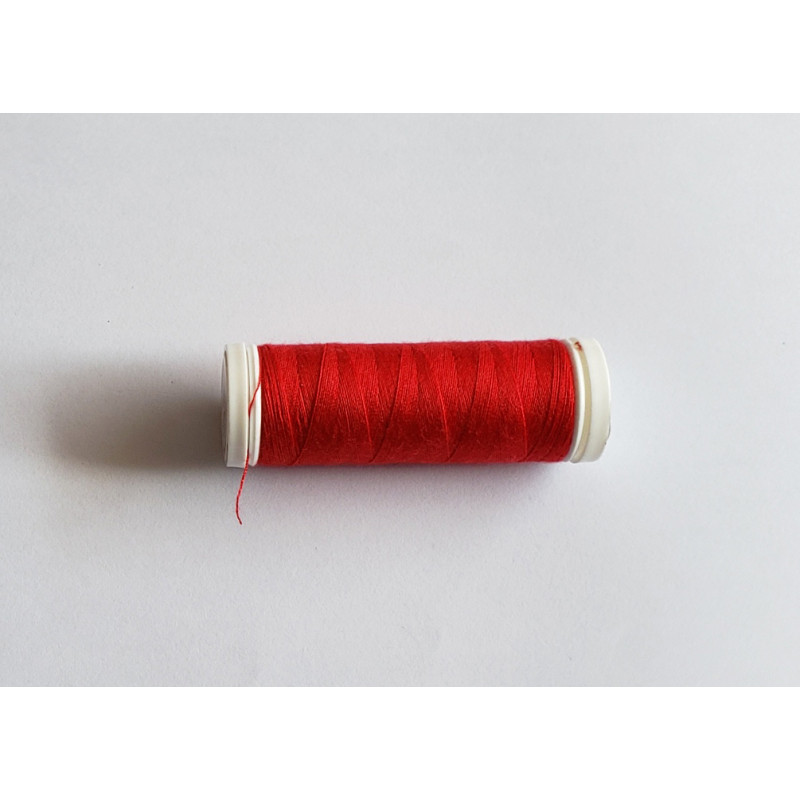 Sewing machine thread - light red color - 200m spool, placed on a white background