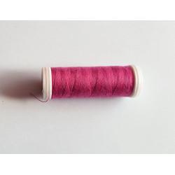 Sewing machine thread - dark rose pink color - 200m spool, placed on a white background